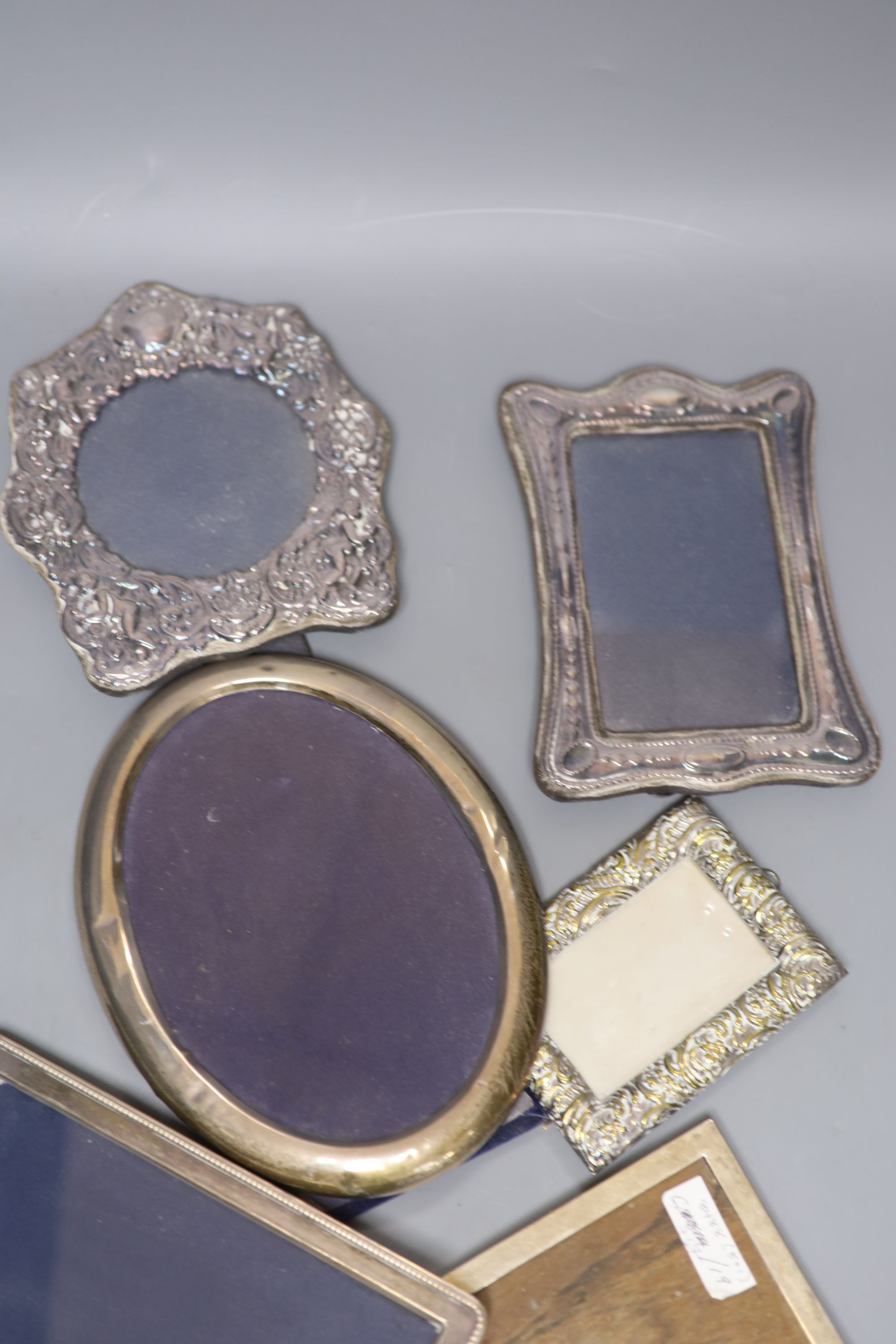 Four assorted silver mounted photograph frames, largest 21cm, one other white metal frame and a brass frame.